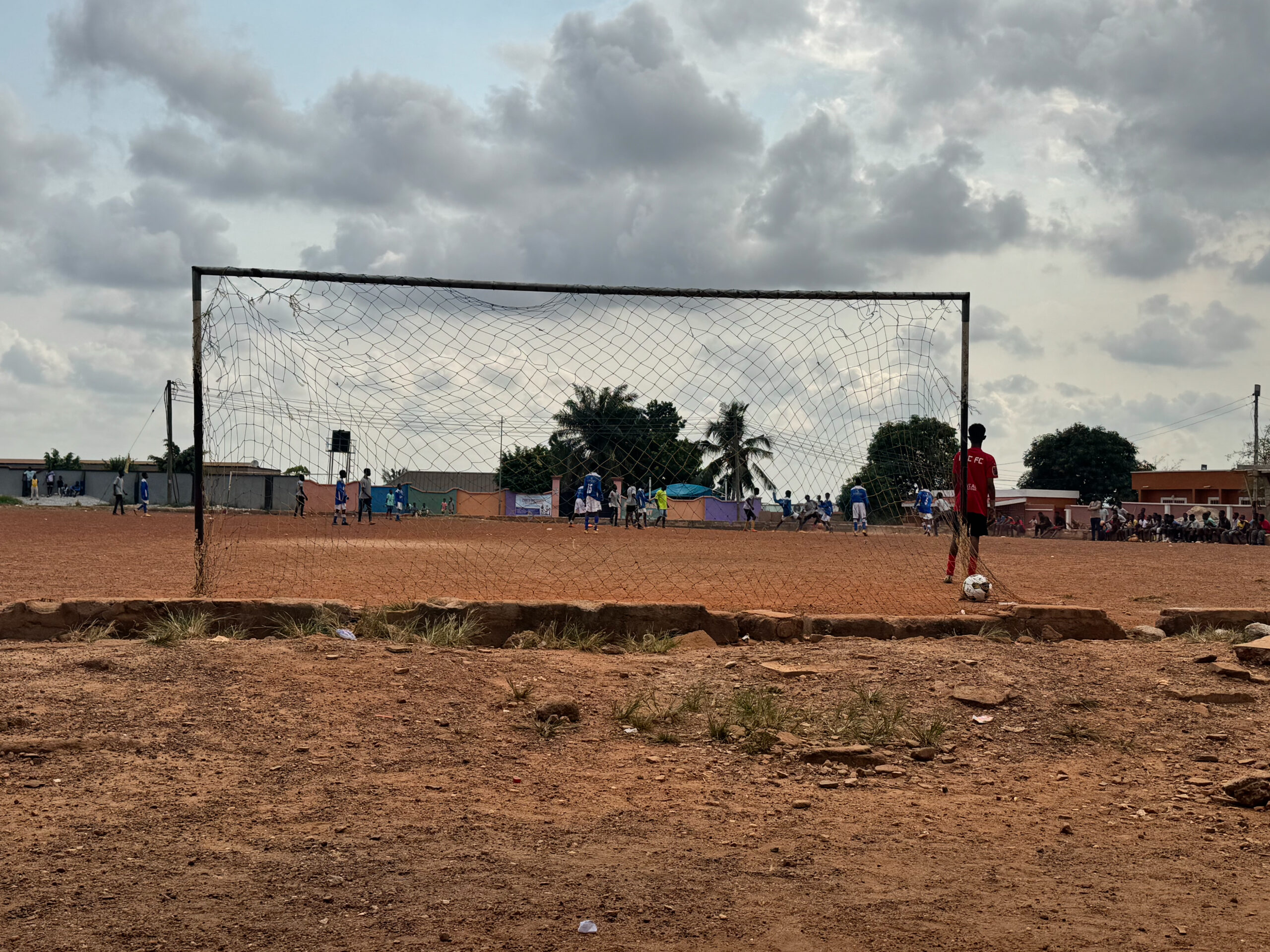 Field Notes 005 – Image 1 Dr. Mimi Nartey overlooking the academy field in Kumasi, Ghana.