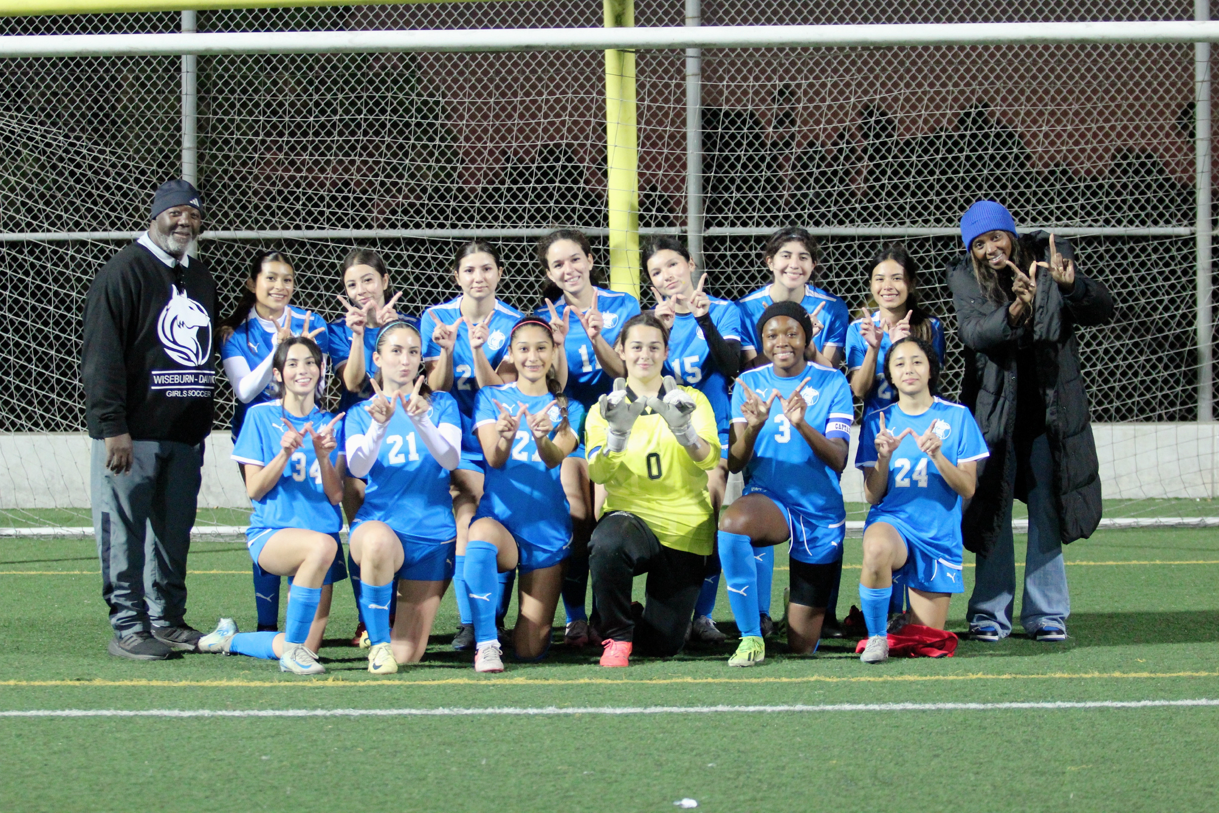 The Wiseburn Da Vinci girls' soccer team together on the field after a match.