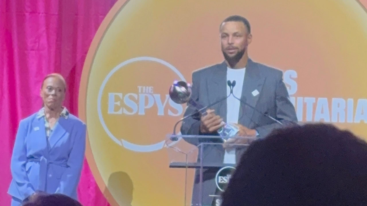 Installer presentation at ESPYS event with speaker and audience.