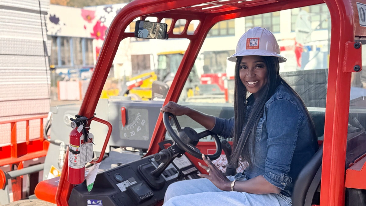 Smiling woman construction worker in Oakland during Super Bowl week.