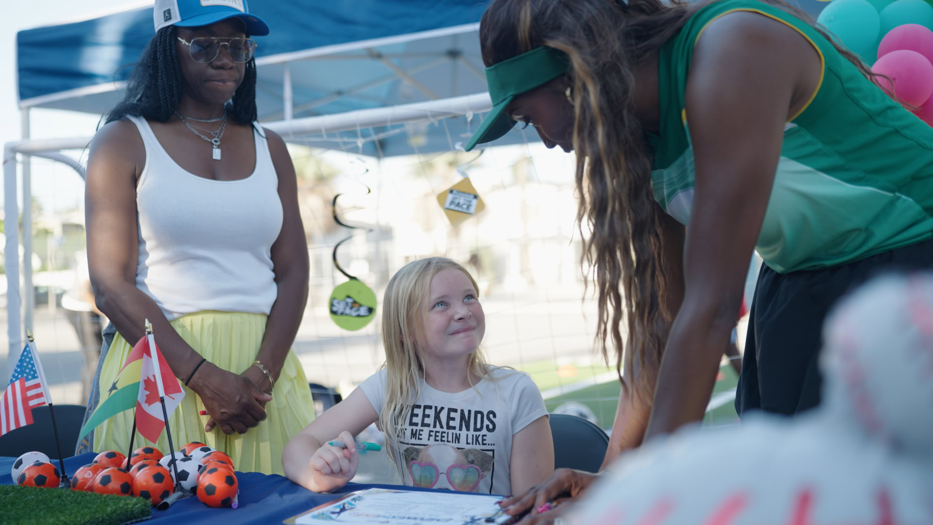 Person installing WordPress theme with a young girl at an outdoor event.